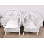 A pair of cane armchairs.