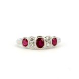 A 950 platinum ring set with oval cut rubies and brilliant cut diamonds, (L.5).