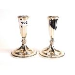 A pair of weighted sterling silver candlesticks, H. 15cm.