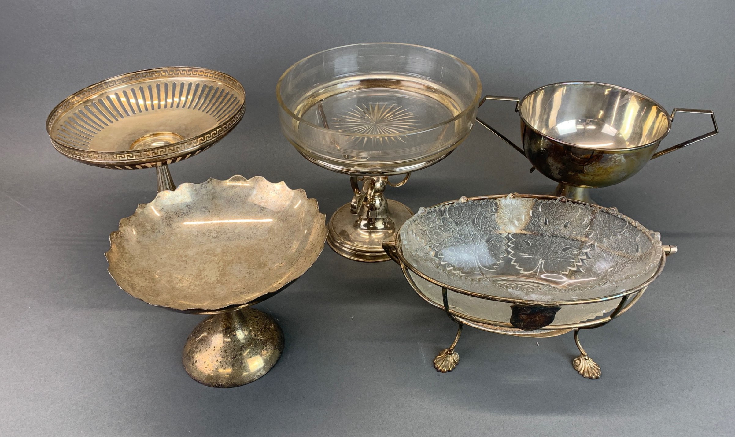 A silver plate and glass basket, W. 29cm and four further silver plated items.