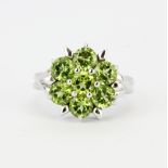 A matching 925 silver cluster ring set with round cut peridots, (O.5).