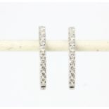 A pair of hallmarked 18ct white gold hoop earrings set with brilliant cut diamonds, approx. 0.56ct