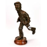A 19th century painted spelter figure of a newspaper boy mounted on a wooden base, H. 36cm.