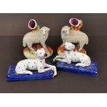 A pair of Staffordshire pottery sheep, H. 13cm, together with a pair of later porcelain dogs.