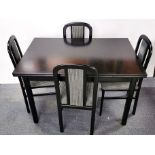 A contemporary black finished table and four chairs, table size 120 x 80cm.