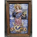 A 19th century Continental (possibly Spanish) framed ceramic relief decorated two tile panel of