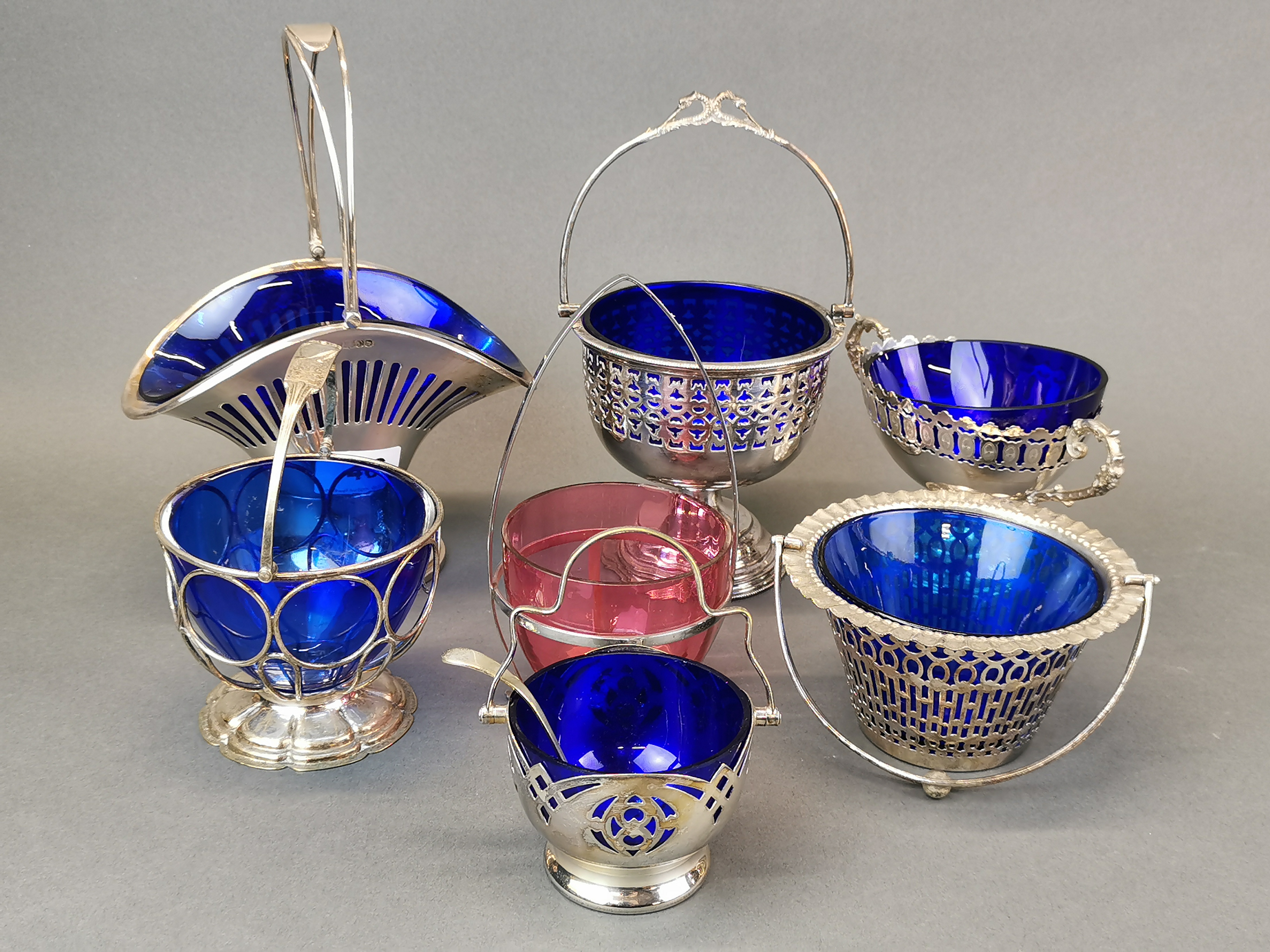 A group of silver plate and glass table baskets, tallest H. 25cm.