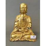 A Tibetan gilt bronze figure of a seated Buddha, H. 25cm.