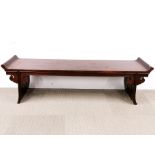 A Chinese carved hardwood low altar table, L. 160cm, H. 45cm. Minor scuffing to scroll ends.
