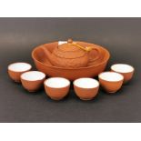 A Chinese Yi Xing terracotta miniature tea pot and tea ceremony set, spout to handle L. 12cm, H.