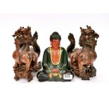 A Chinese carved wooden figure of a seated Buddha, H. 21cm, together with a pair of carved wooden