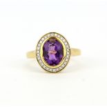 A hallmarked 18ct yellow gold ring set with a large oval cut amethyst, approx. 1.74ct, surrounded by