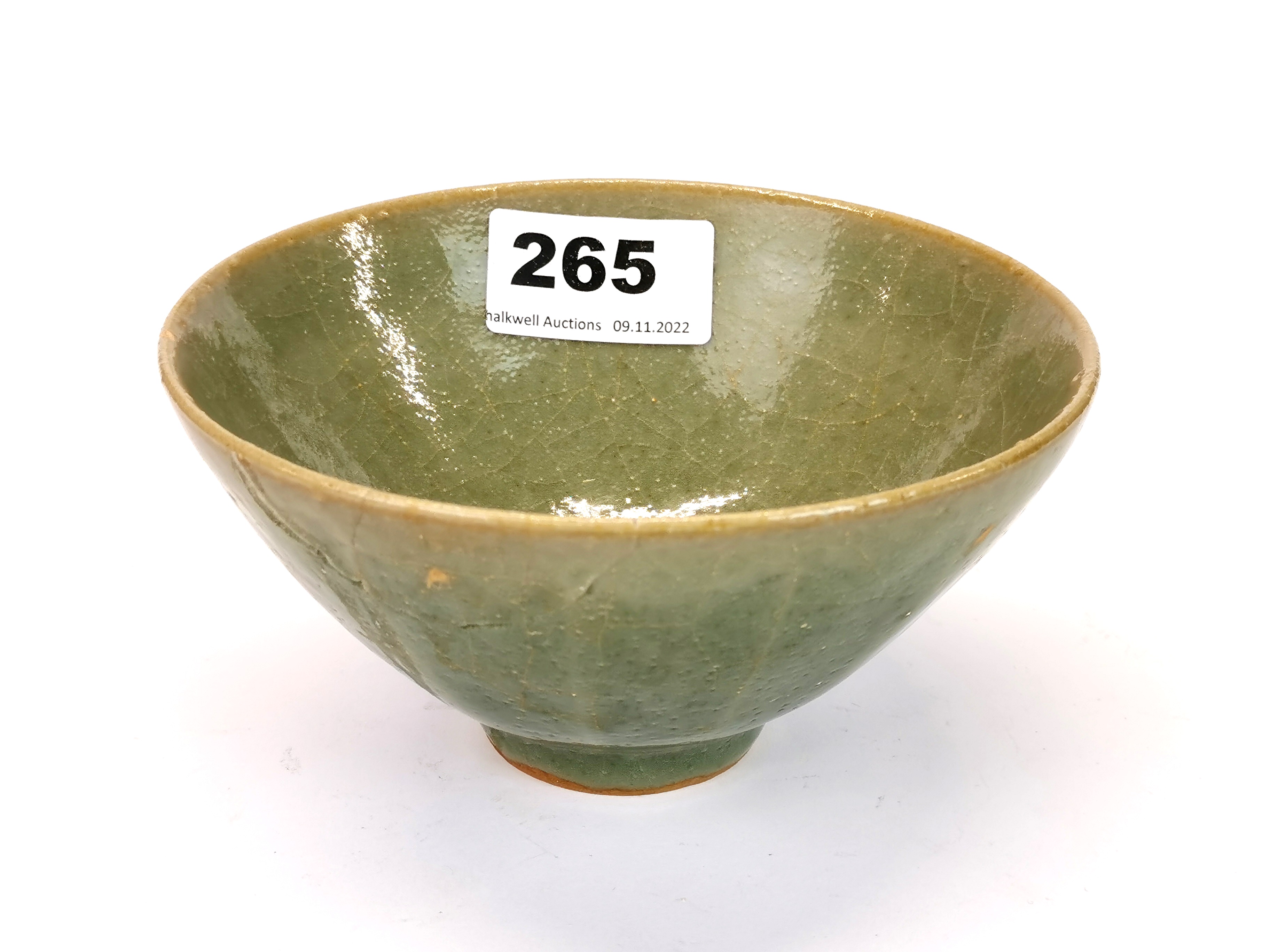A Chinese celadon crackle glazed lotus bowl, Dia. 14cm, H. 7cm. Slightly A/F.