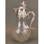 An impressive silver plate and etched glass water jug, mounted with a lion and shield, H. 31cm.