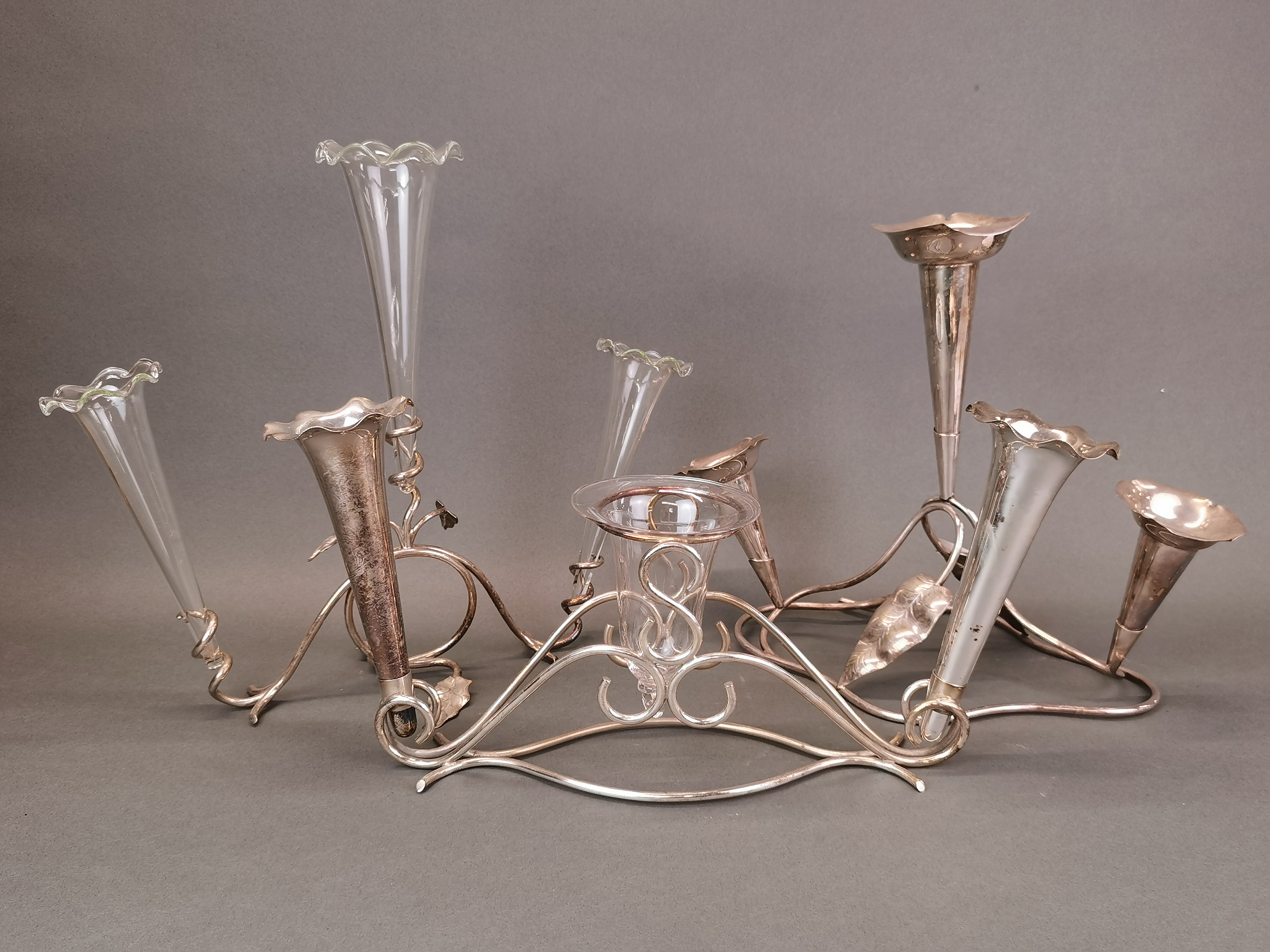 Three silver plate and glass epergne centrepieces, tallest H. 31cm.