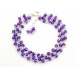 A 925 silver bracelet set with three rows of amethyst beads, L. 17cm.