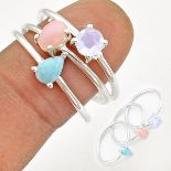 Three 925 silver stacking rings set with larimar, pink opal and moonstone.