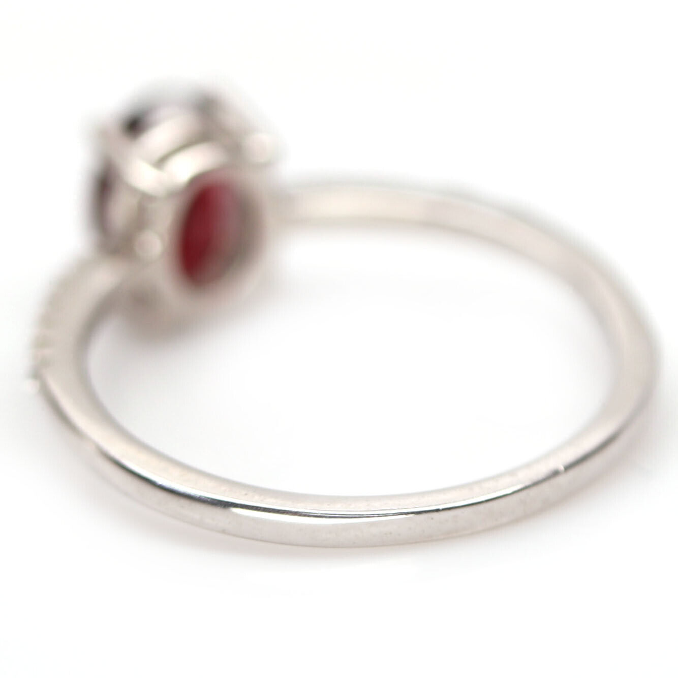 A 925 silver ring set with an oval cut garnet and white stone set shoulders, (N.5). - Image 3 of 3