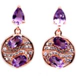 A pair of rose gold on 925 silver drop earrings set with oval cut amethysts and white stones, L. 2.