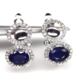 A pair of 925 silver earrings set with oval cut sapphires and white stones, L. 1.6cm.