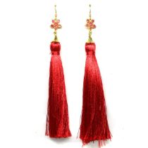 A pair of gold on 925 silver drop earrings set with rubies, with long red silk tassels.