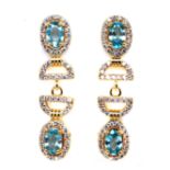 A pair of gold on 925 silver drop earrings set with oval cut seafoam blue topaz and white stones, L.