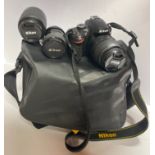 A Nikon camera, lenses and case.