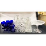 A group of cut crystal decanters and other glassware.