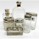 A group of hallmarked silver topped dressing table items.