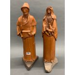 A pair of large hand made terracotta figures of Jewish characters standing on rock bases, H. 53cm.