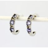 A pair of 9ct white gold (stamped 9K) hoop earrings set with round cut tanzanites and diamonds, L.