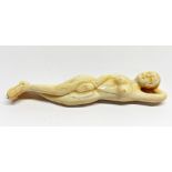 An oriental carved bone medical figure of a naked woman, L. 13cm.