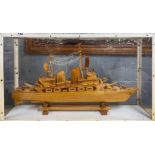 A cased wooden model of a Naval vessel, case size 77 x 16 x 44cm.