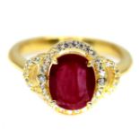 A gold on 925 silver ring set with oval cut ruby and white stones, (N).