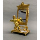 A small gilt metal cherub mirror, H. 23cm.