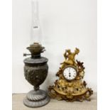 A 19th century spelter oil lamp, H. 60cm, together with a 19th century gilt spelter mantel clock