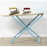 A vintage childs folding ironing board and two irons, L. 53cm.