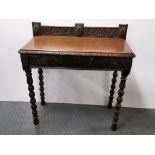 A carved oak single drawer side table, 86 x 85 x 40cm.