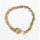 A 9ct yellow gold gate bracelet, L. 21cm.