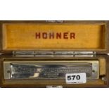 A boxed vintage Hohner chromatic professional model harmonica.