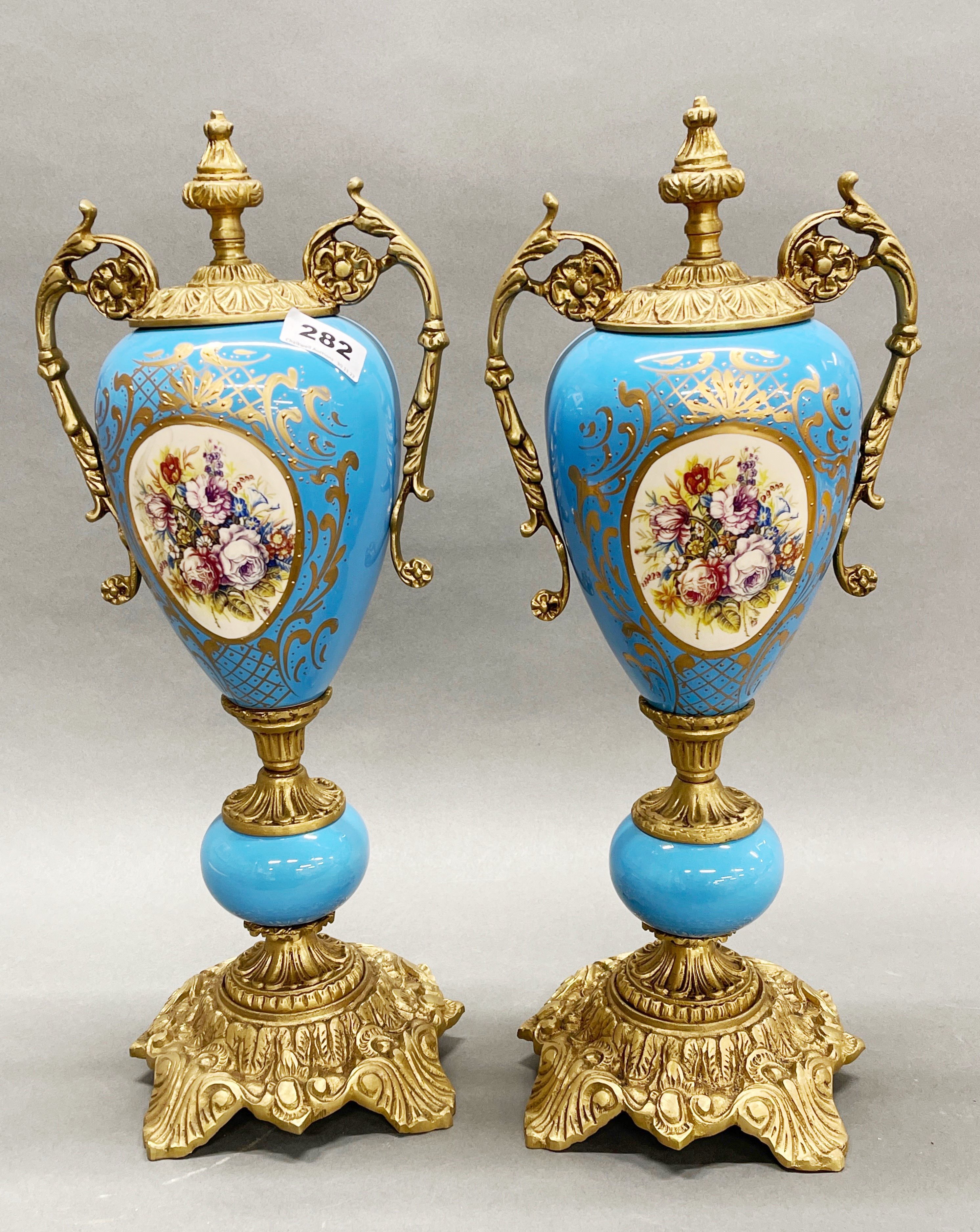 A pair of French ormolu mounted porcelain garnitures, H. 46cm.