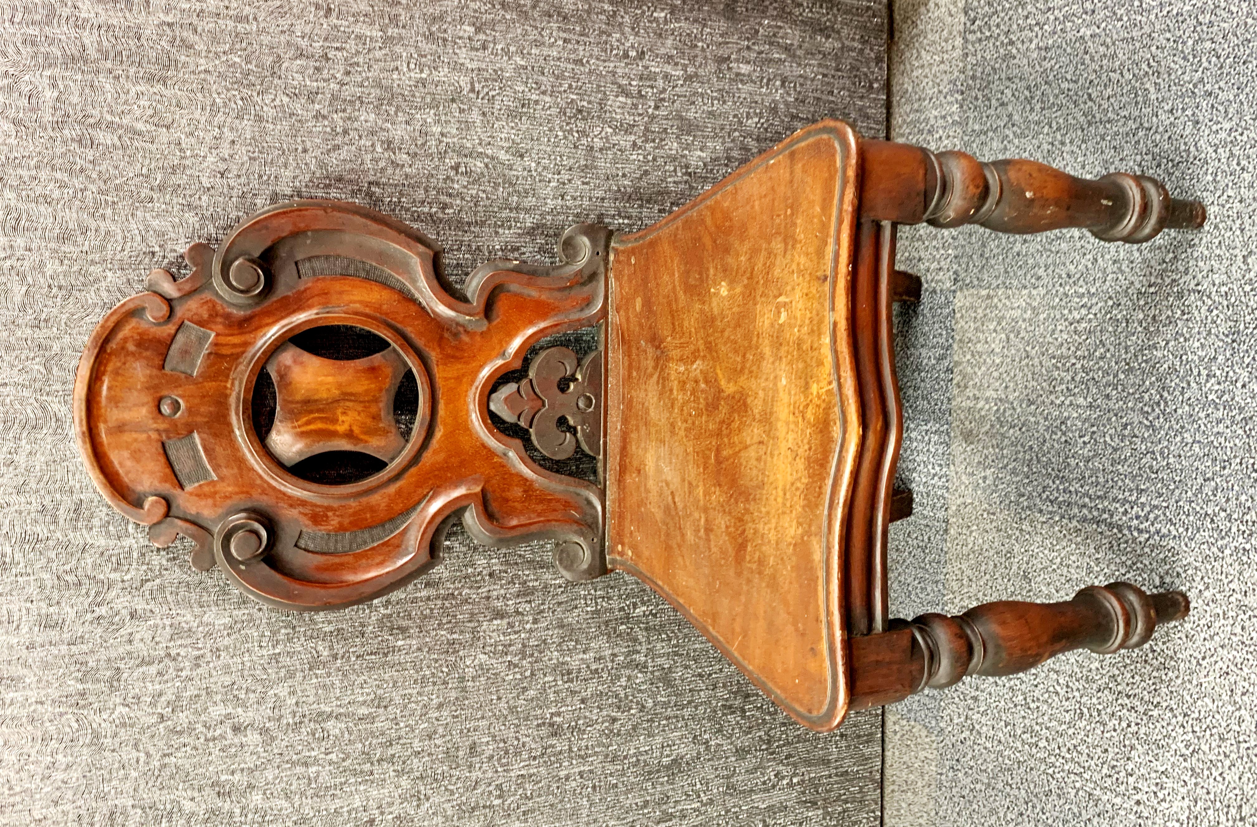 A 19th century carved mahogany hall chair.