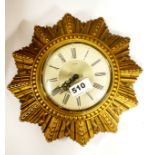 A mid 20th century Smiths mechanical sunburst wall clock, W. 24cm.