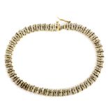 A 9ct yellow gold diamond set bracelet, L. 19cm. One diamond missing.