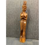 A large freestanding carved teak figure of a woman, H. 102cm.
