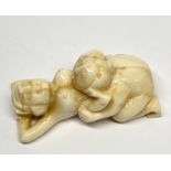 A Japanese carved erotic bone netsuke, L. 5.5cm.