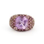 A hallmarked silver ring set with a large cushion cut amethyst and round cut pink topaz, (P).