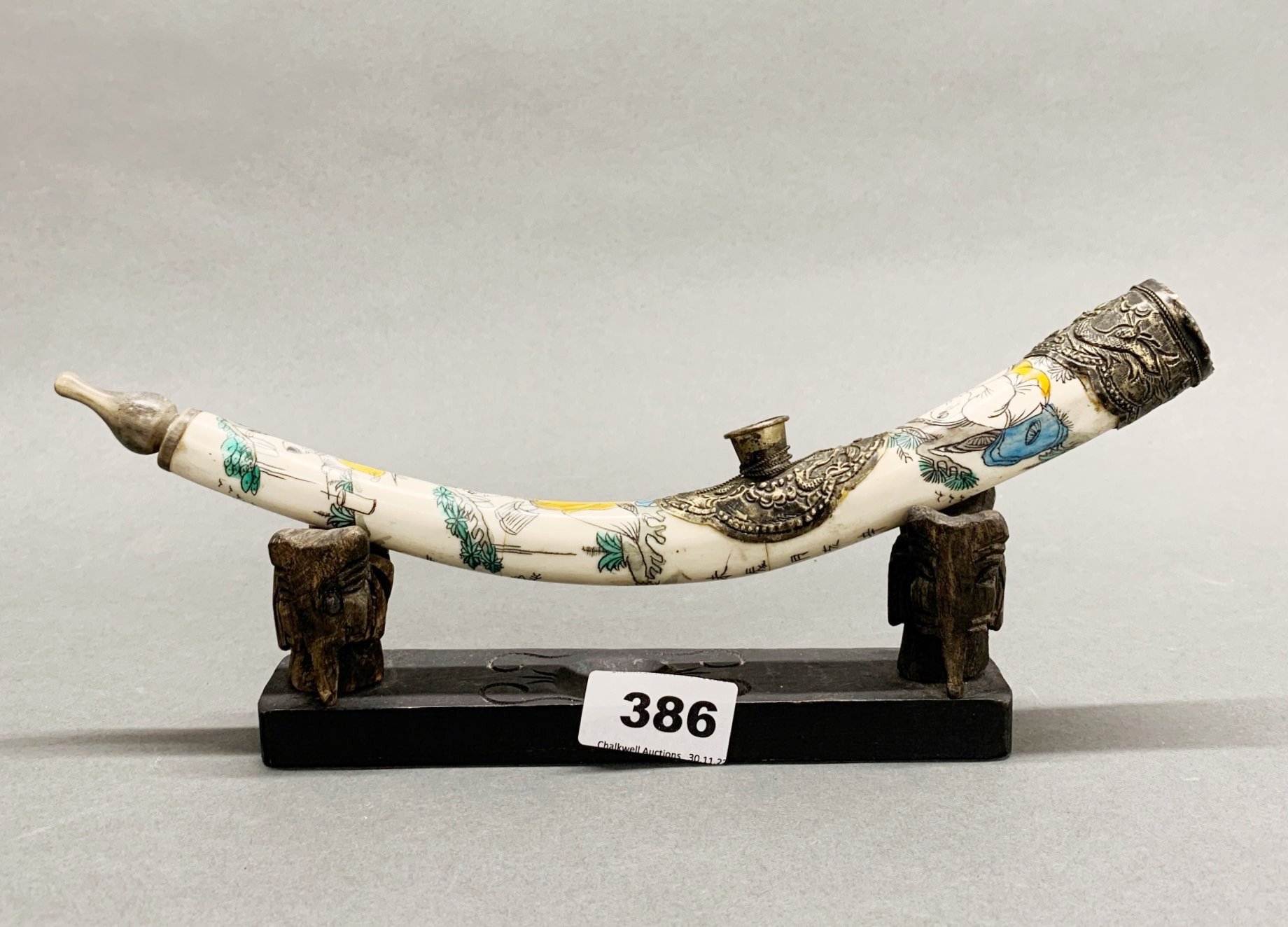 A Chinese painted bone, horn and white metal opium pipe and stand, L. 30cm.