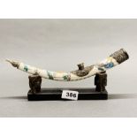 A Chinese painted bone, horn and white metal opium pipe and stand, L. 30cm.