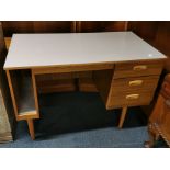 A Formica topped 1970's three drawer desk with screw on legs, 107 x 75 x 59cm.